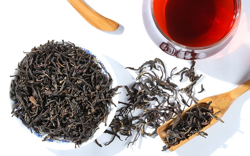 Cánh hồng trà Shan Tuyết khô và nước trà màu đỏ hổ phách